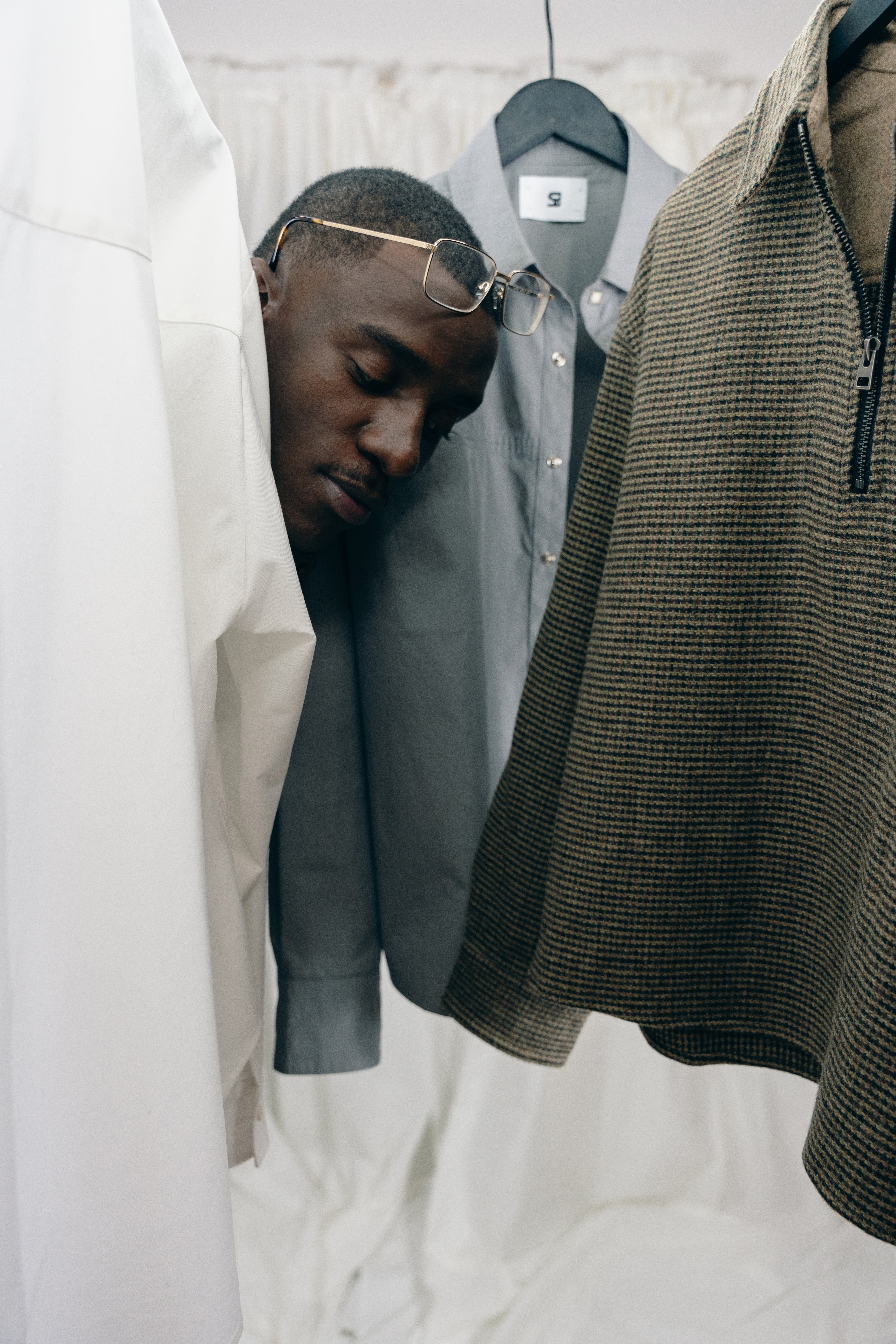 Model facing behind hanging clothing pieces from misela studios