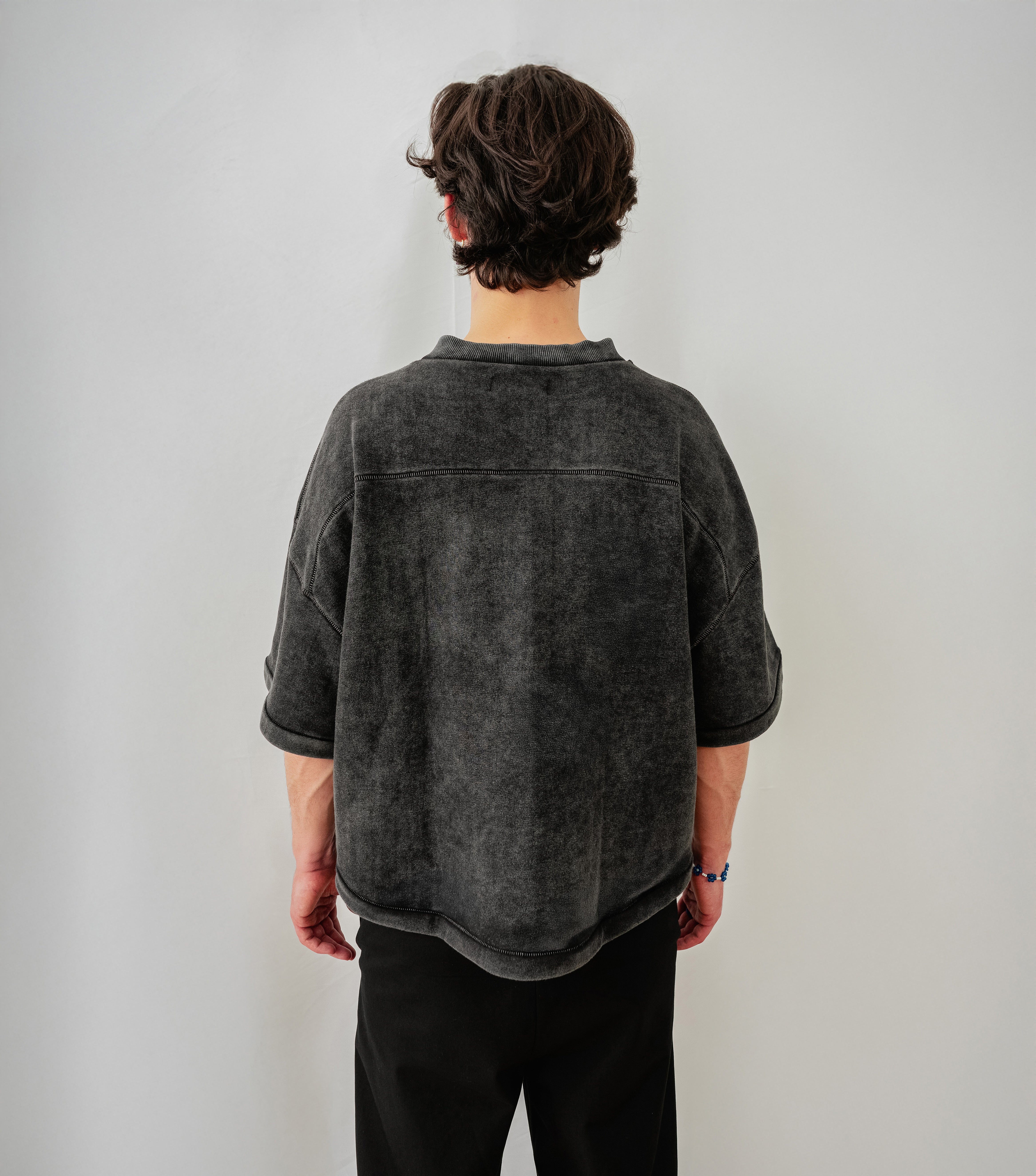 Model is wearing Cropped Baseball T-Shirt in Faded Black with V-Neck and Heavyweight Cotton - Backview