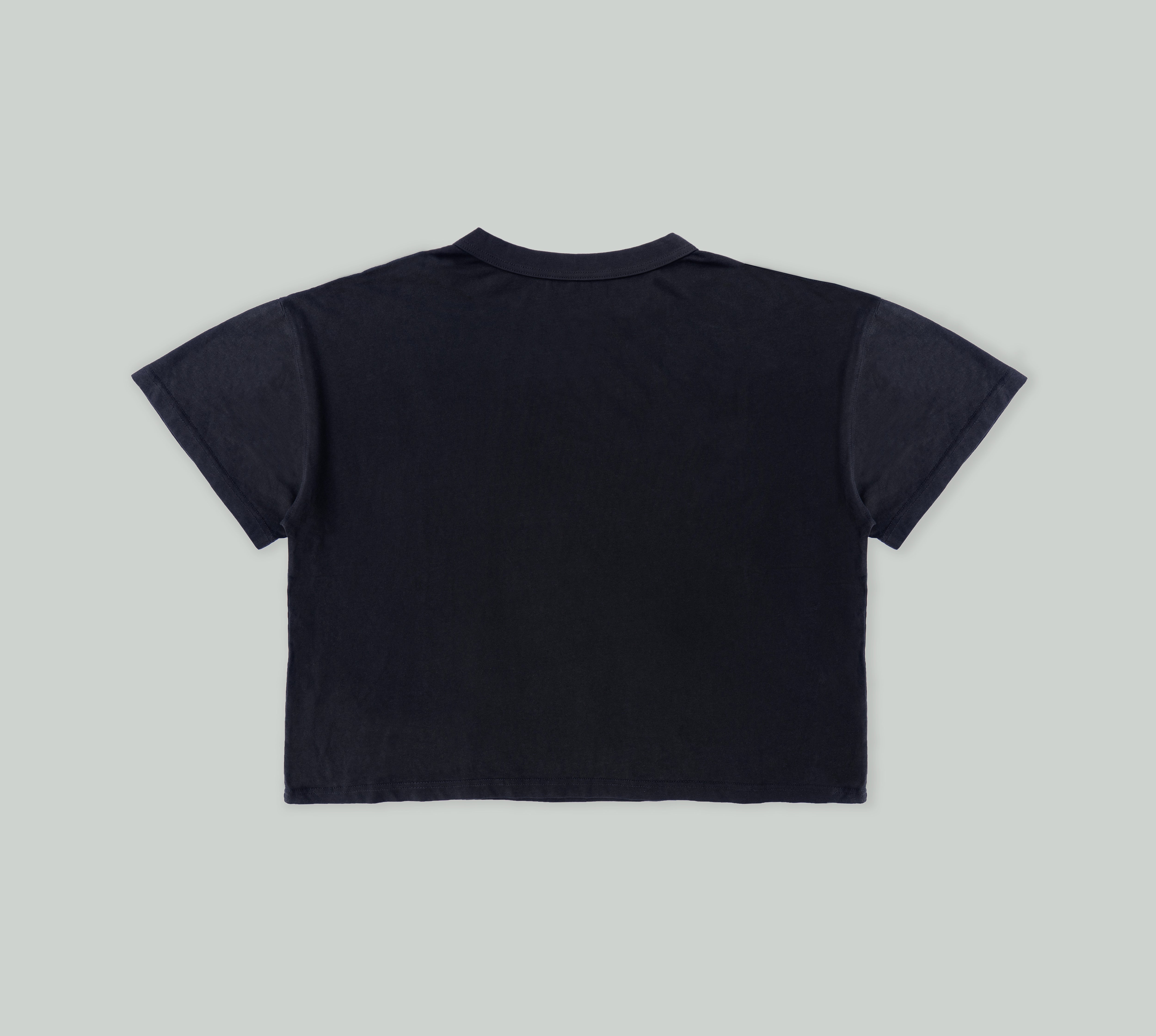 Signature Pearl Tee in Black from Misela Studios in front of a cloth screen - Backview