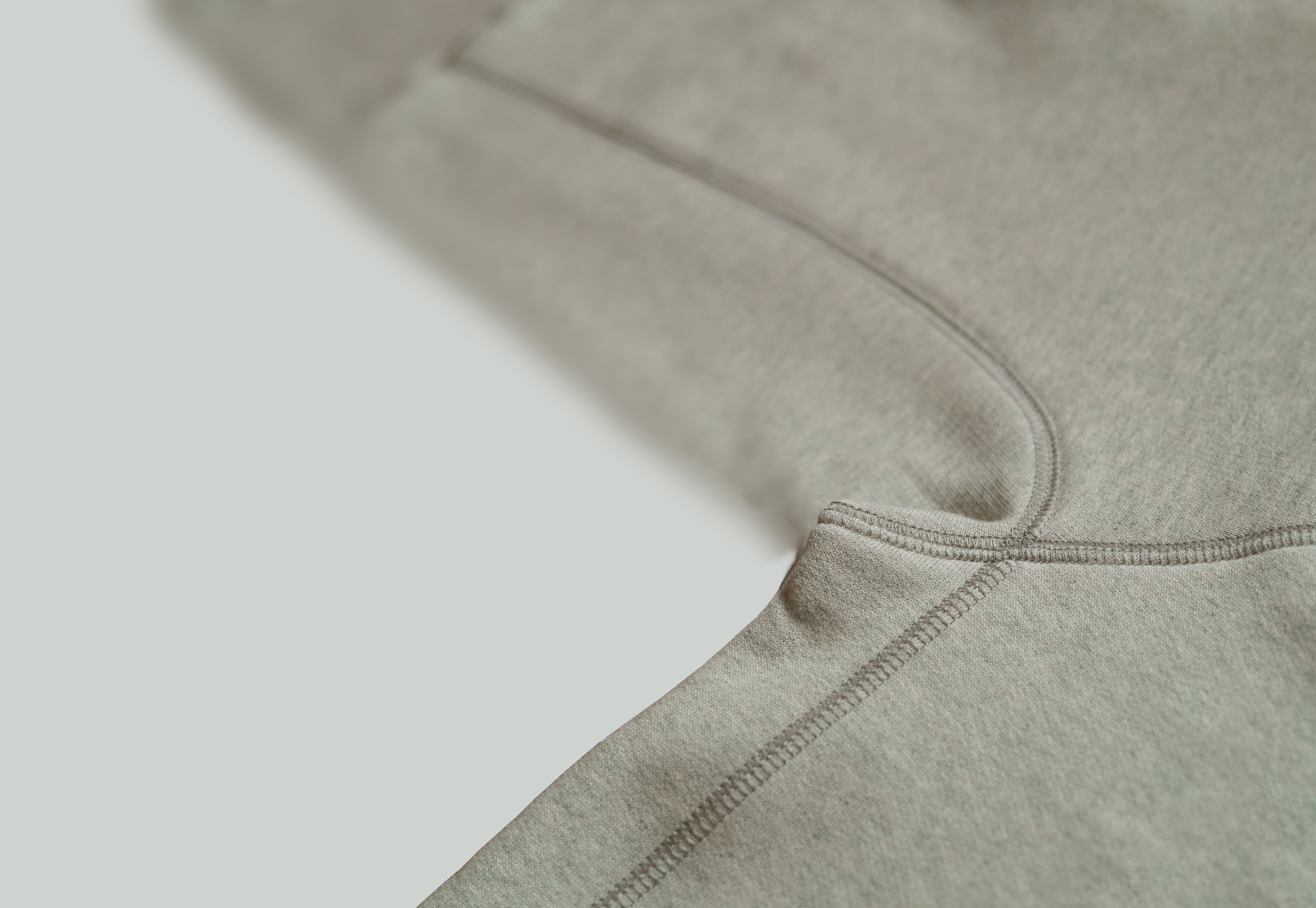 
Loose Fit Hoodie in Grey/Beige from Misela Studios with Hood and front pocket with thread detail